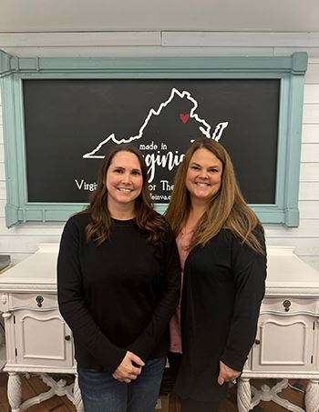 Two women standing in downtown Fredericksburg, VA store.