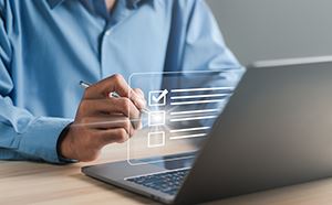 Man's hand holding pin to check off items.