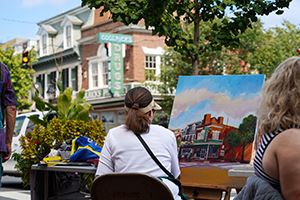 Artist painting Goolricks Pharmacy.