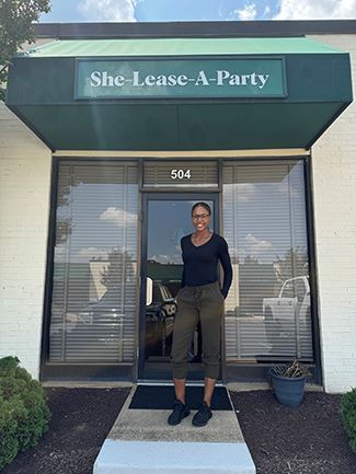 Woman standing in front of office building.