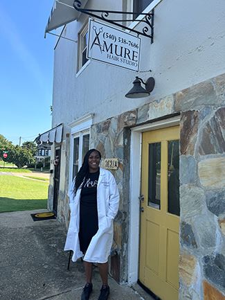Woman standing in front of building.